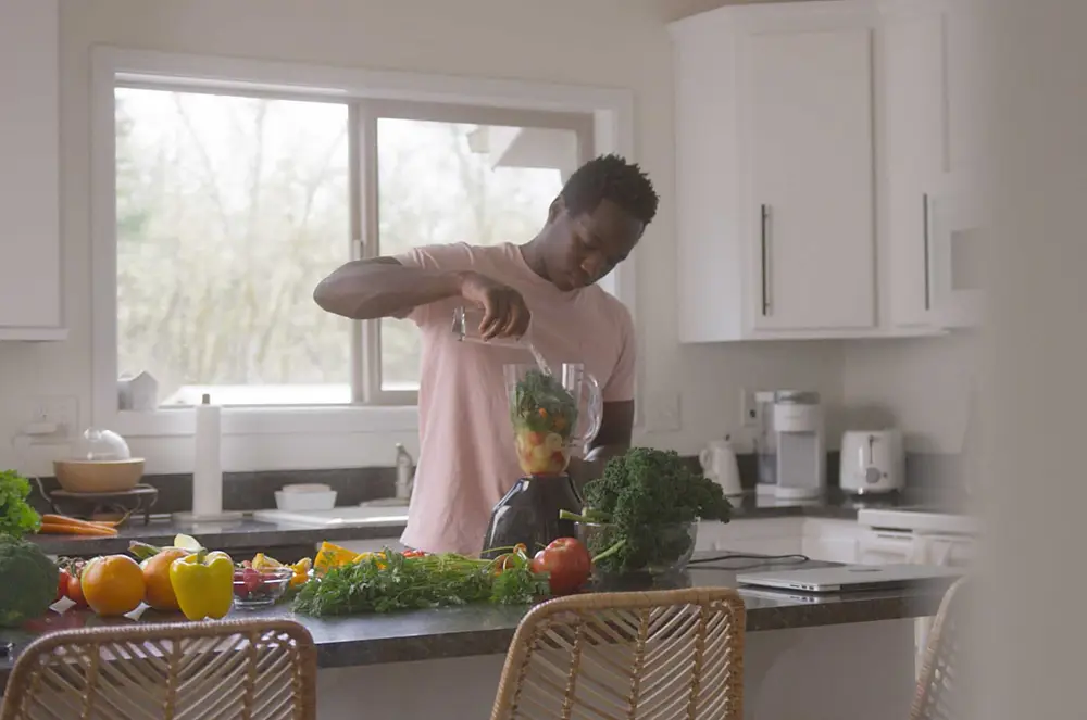 Person preparing healthy food in a bright, modern kitchen