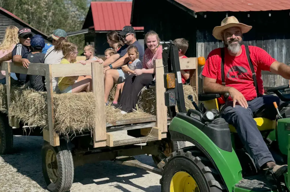 Families enjoying a hayride on a local farm
